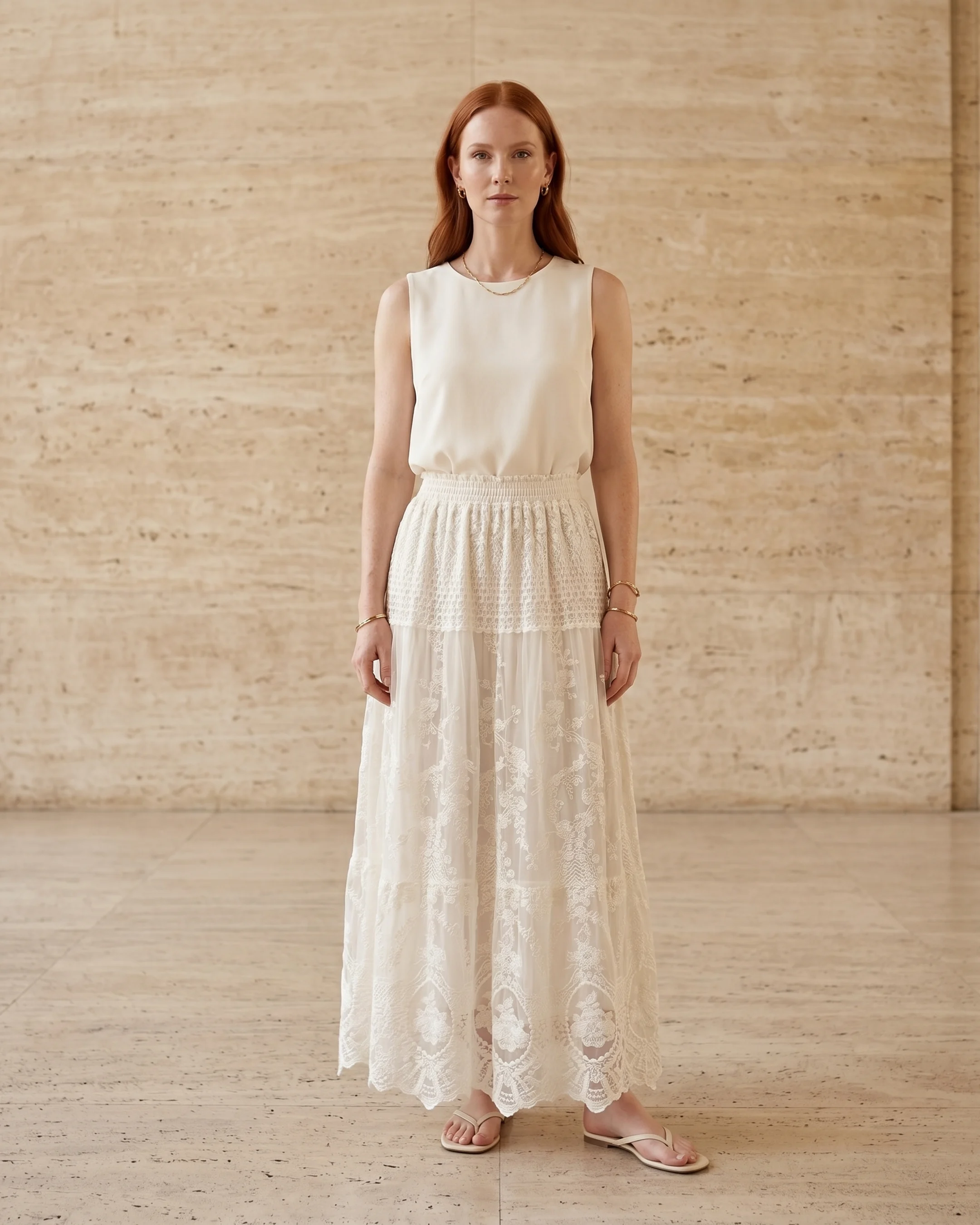 Aemilia floral-embroidered lace A-line chiffon maxi dress in Avorio — full front, on a model in a warm Roman travertine studio for Hugo Caesar Tassi