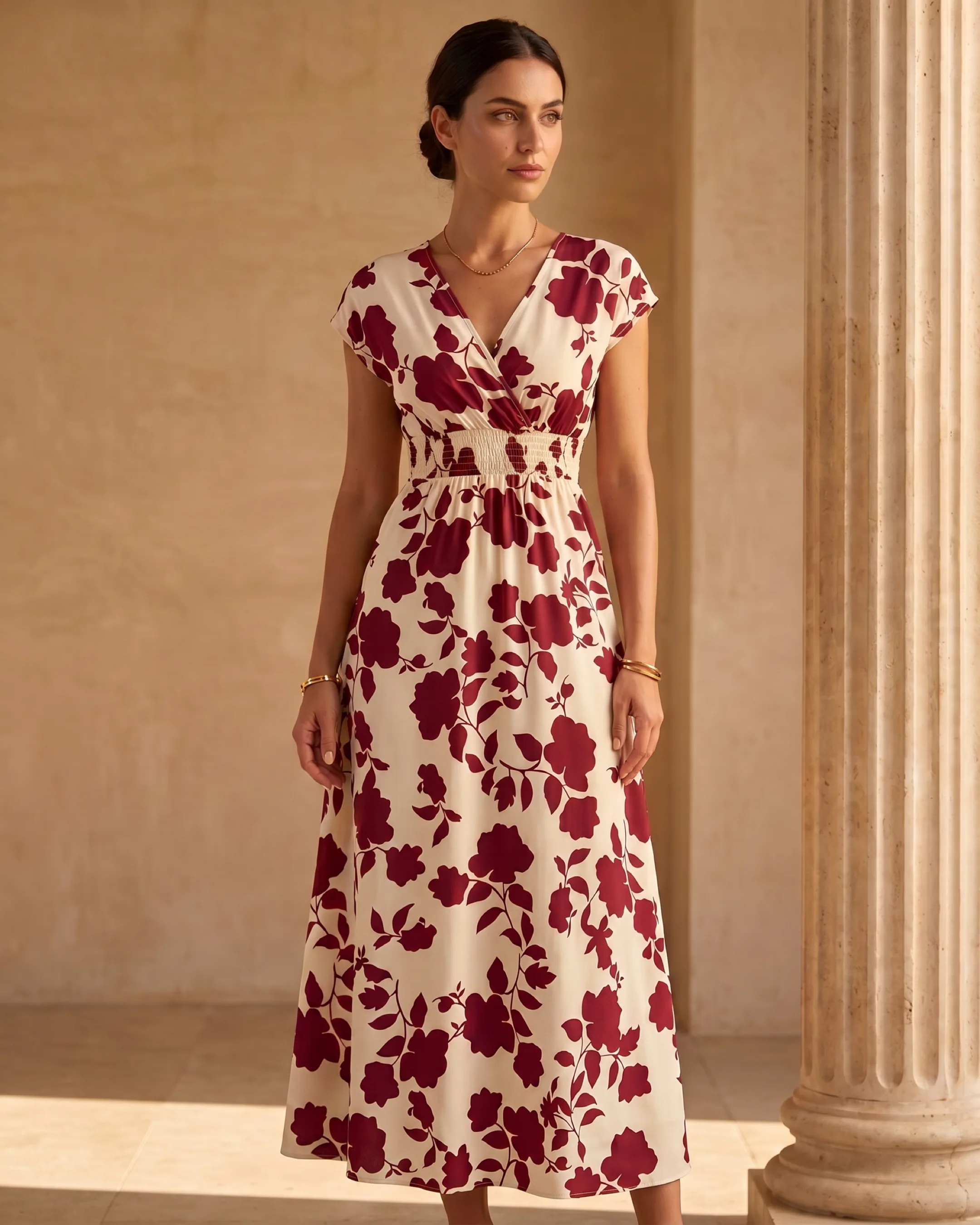 Hugo Caesar Tassi Aurelia self-tie wrap crepe midi dress in Porpora wine-red florals, full-length on the model against a warm travertine wall