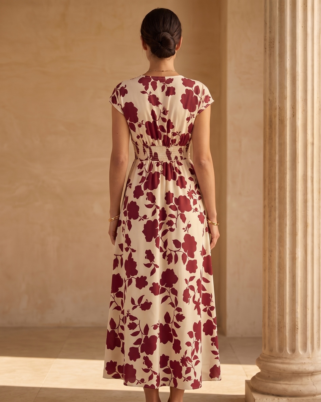 Hugo Caesar Tassi Aurelia full-length rear view showing the back neckline, shirred empire waist and flowing midi hem of the wrap dress