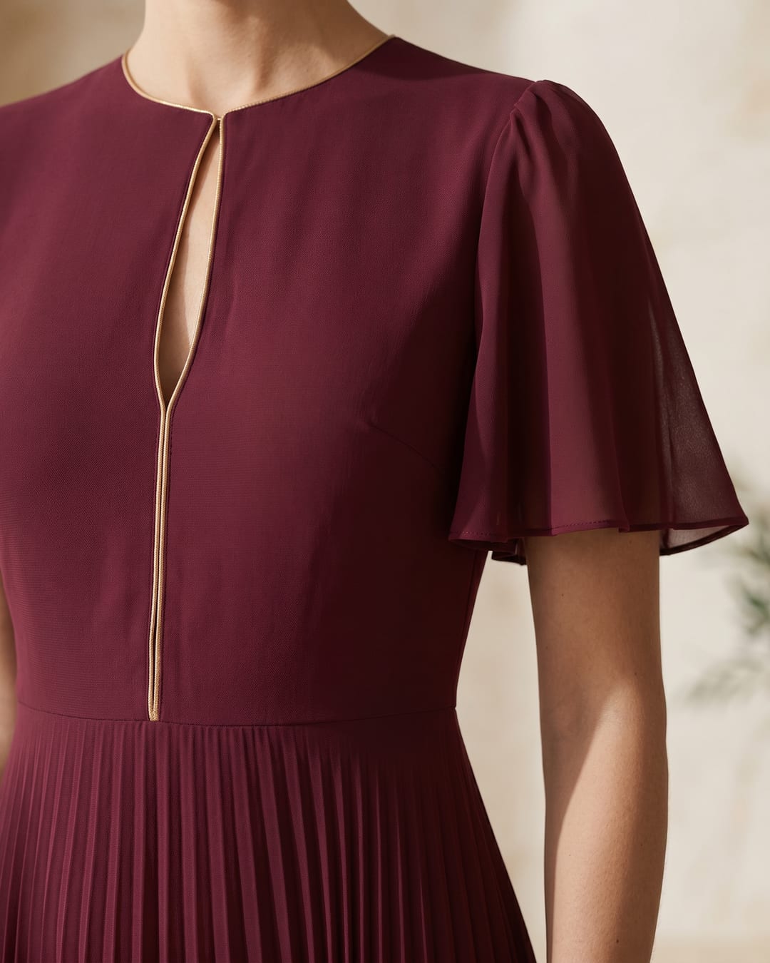 Aurelia dress — gold-trim keyhole cutout bodice and flutter sleeve detail