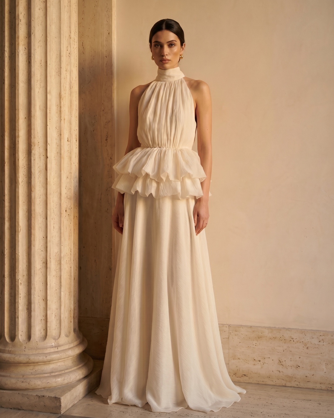 Hugo Caesar Tassi Fulvia stand-collar ruffle crepe dress in Avorio ivory, full-length on the model against a warm travertine wall