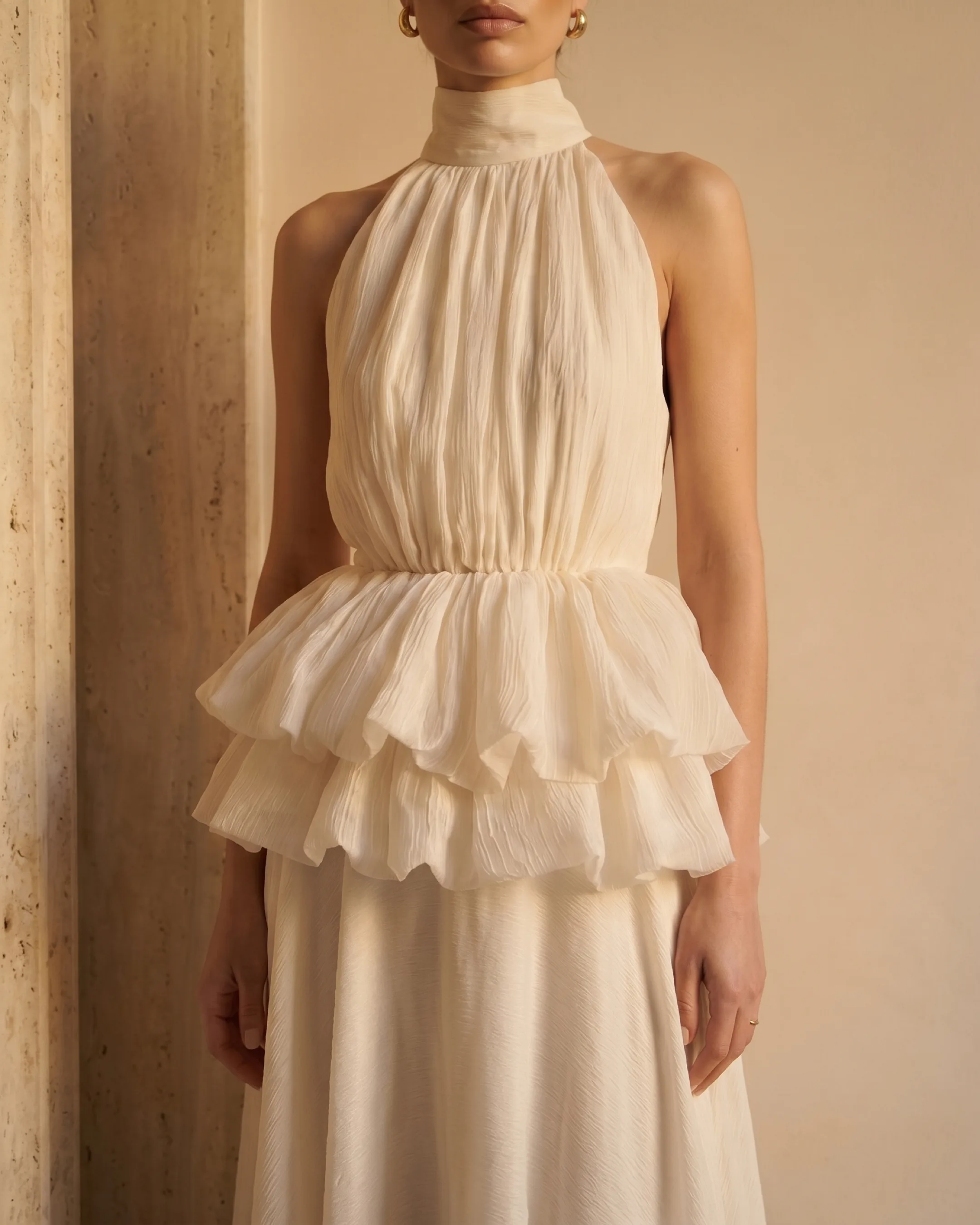 Hugo Caesar Tassi Fulvia close-up of the soft stand collar, gathered bodice and two-tiered ruffle peplum in ivory crepe