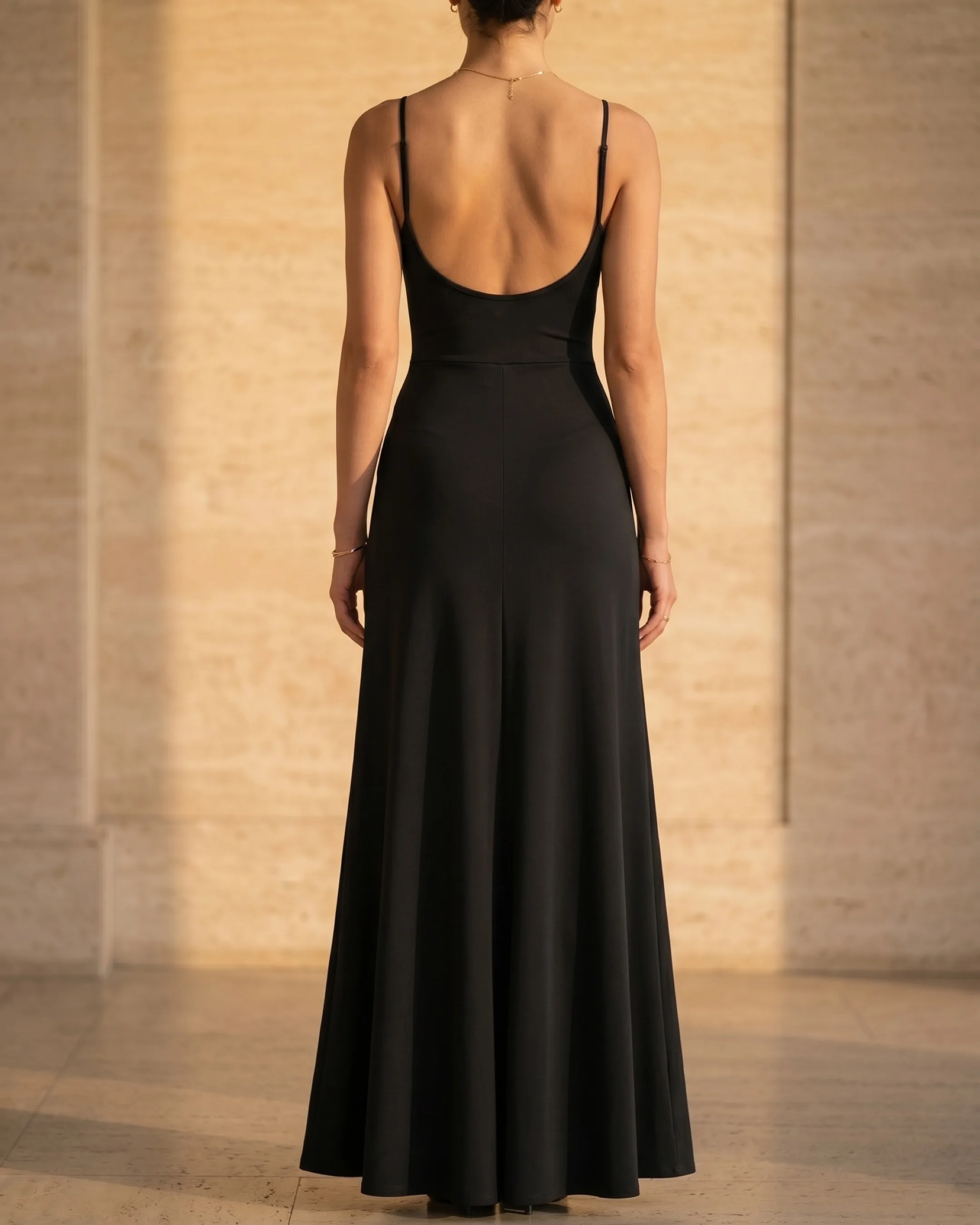 Hugo Caesar Tassi Galla full-length rear view showing the scoop back neckline, fine straps, high-waist seam and long A-line skirt
