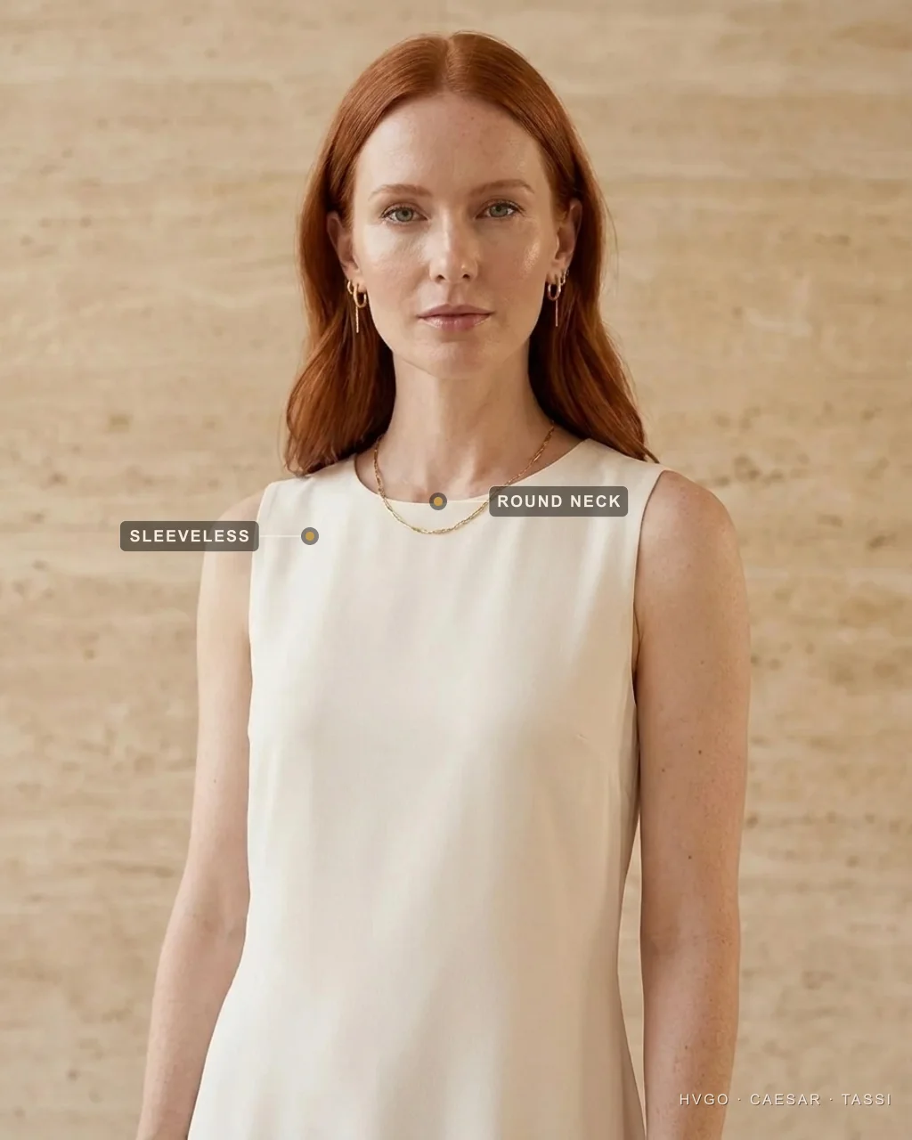 Dress necklines explained — the round jewel neckline — Hugo Caesar Tassi Close view of a woman in a Hugo Caesar Tassi ivory chiffon dress with a soft round jewel neckline, labelled to show the closed round neck sitting high at the throat and the sleeveless armhole, in a Roman travertine studio