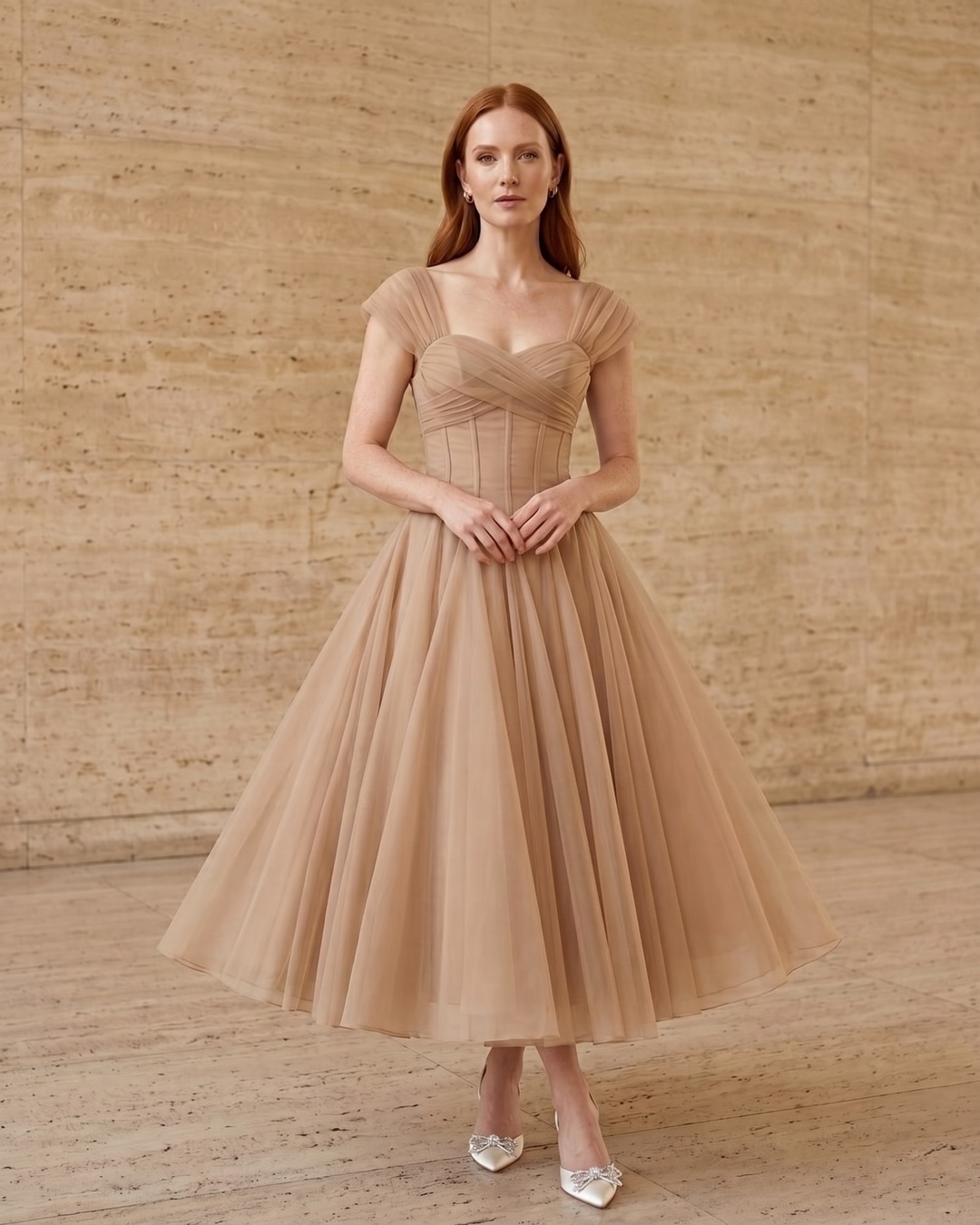 Julia French-style pleated chiffon maxi dress in Travertine apricot — full front, on a model in a warm Roman travertine studio, Hugo Caesar Tassi