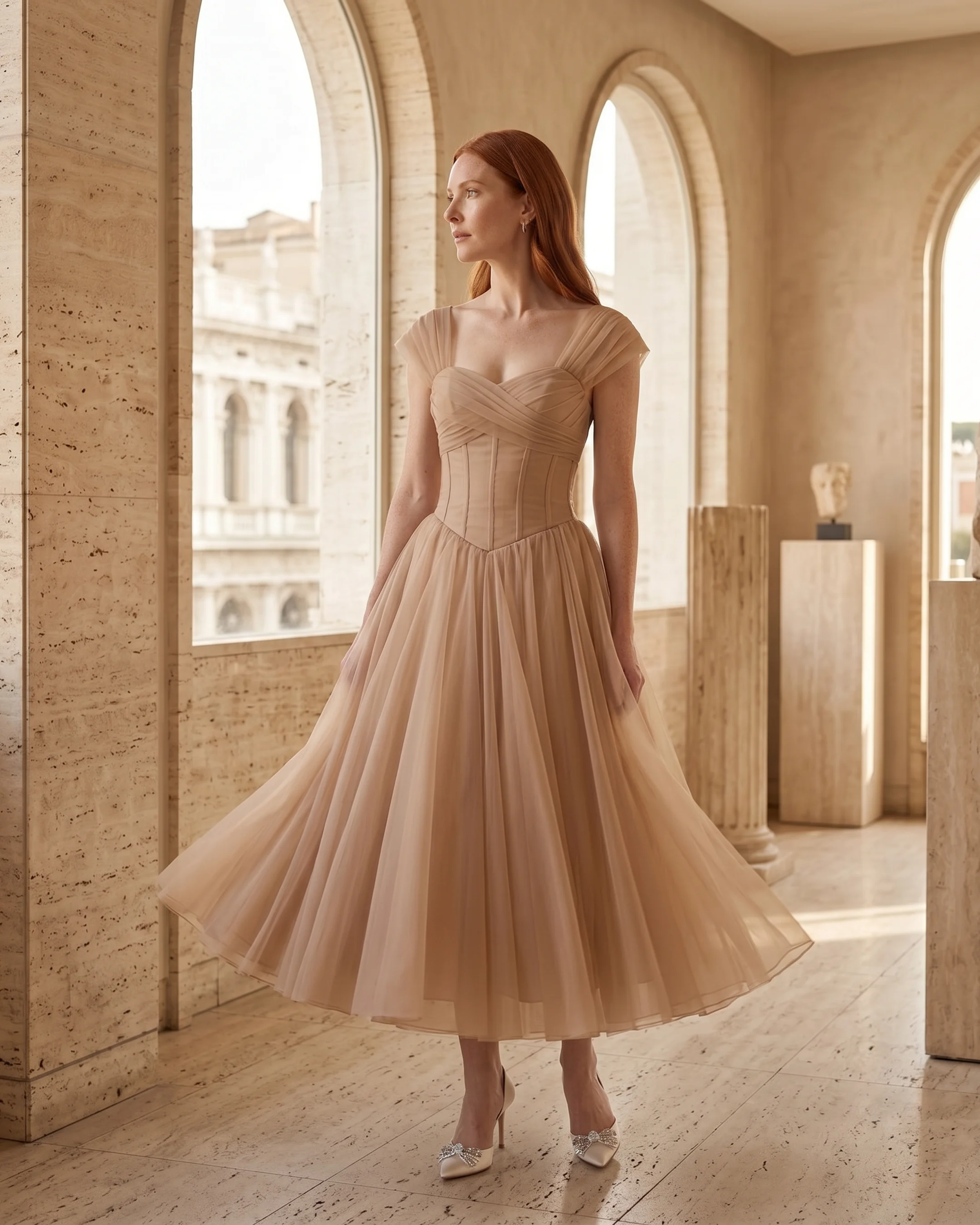 Julia French-style pleated chiffon maxi dress in Travertine apricot — editorial, model beside a fluted Roman column, Hugo Caesar Tassi