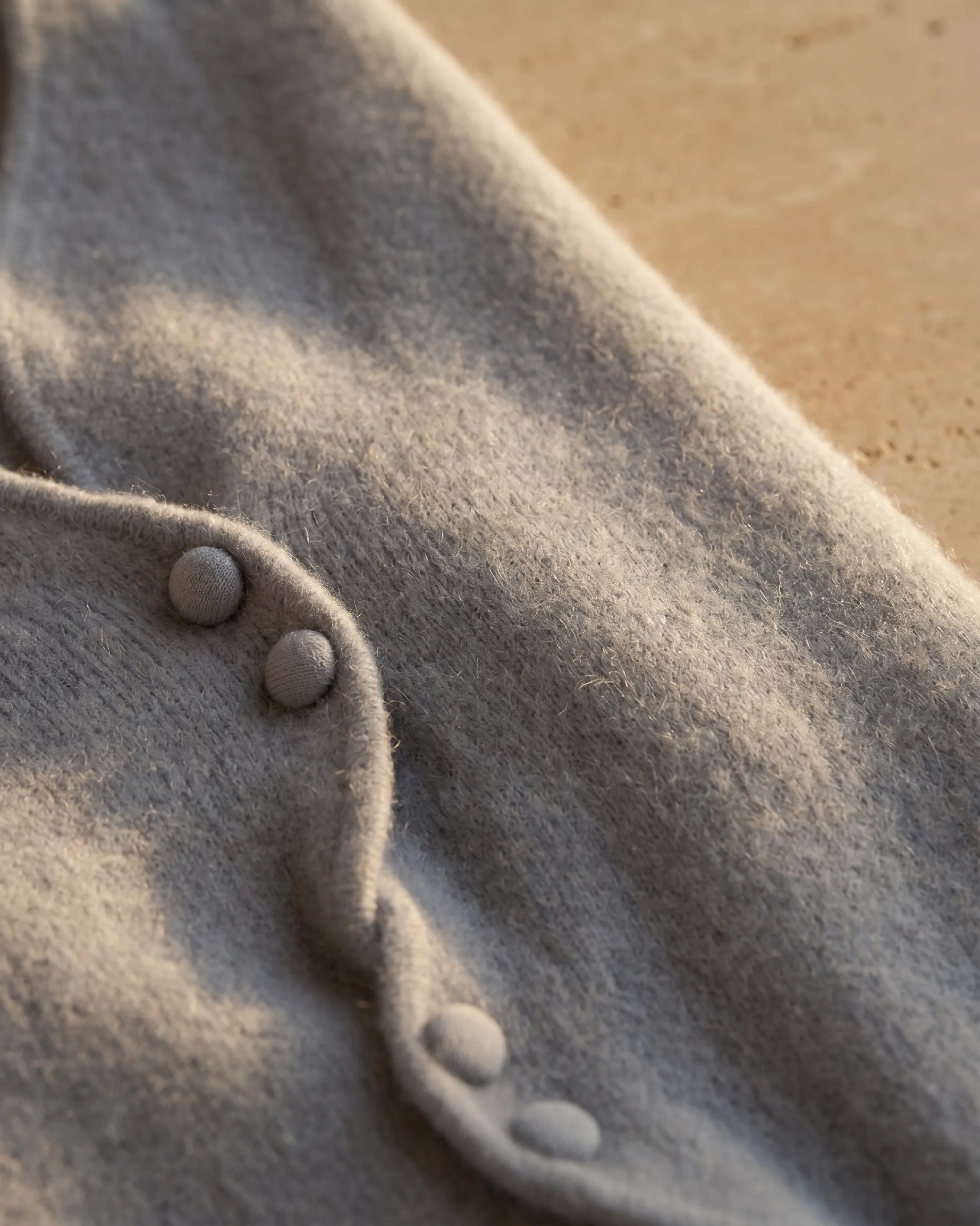 Hugo Caesar Tassi Lucretia soft brushed knit fabric macro with self-covered ball buttons