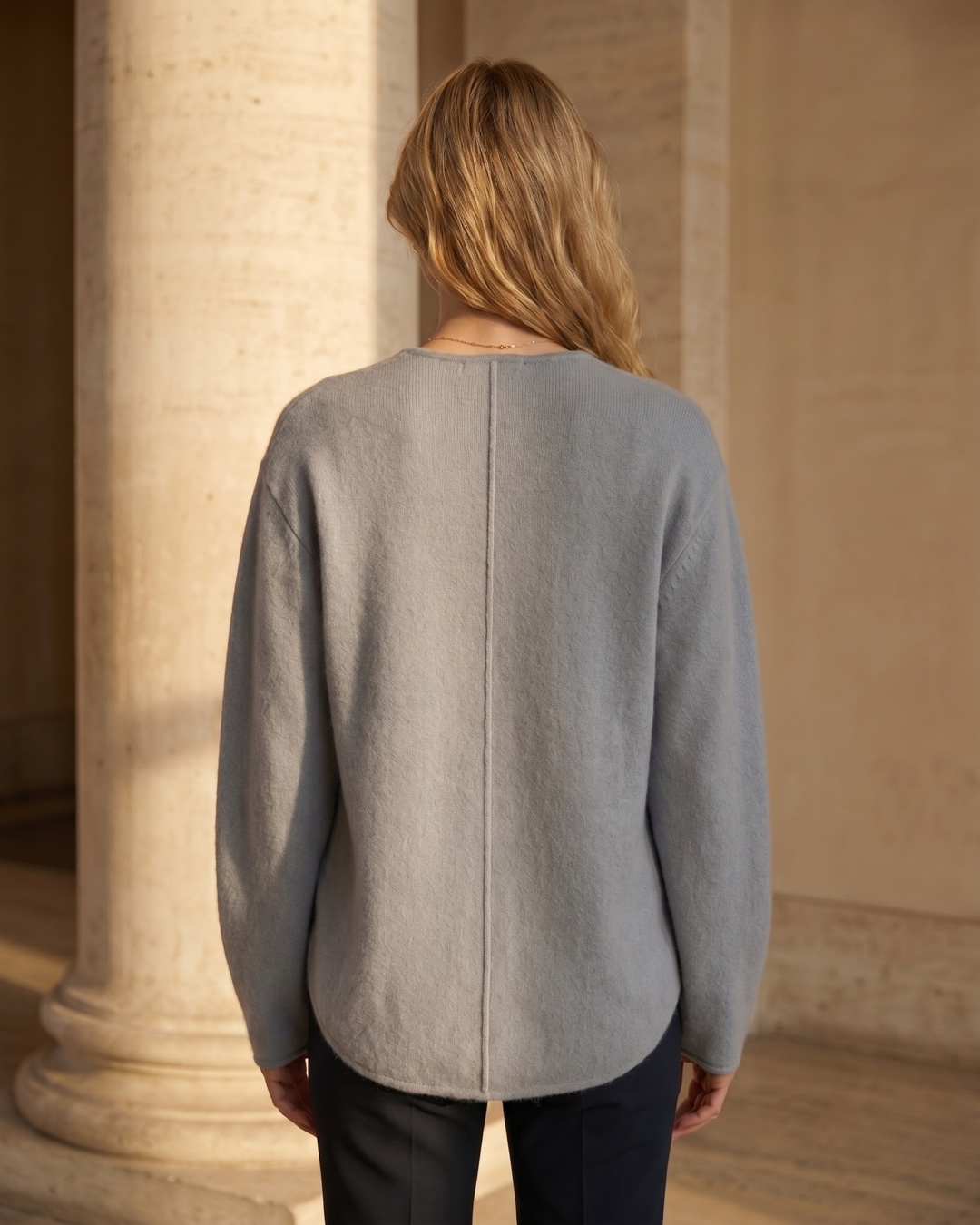 Hugo Caesar Tassi Lucretia full-length rear view showing the smooth knit back panel and curved hem