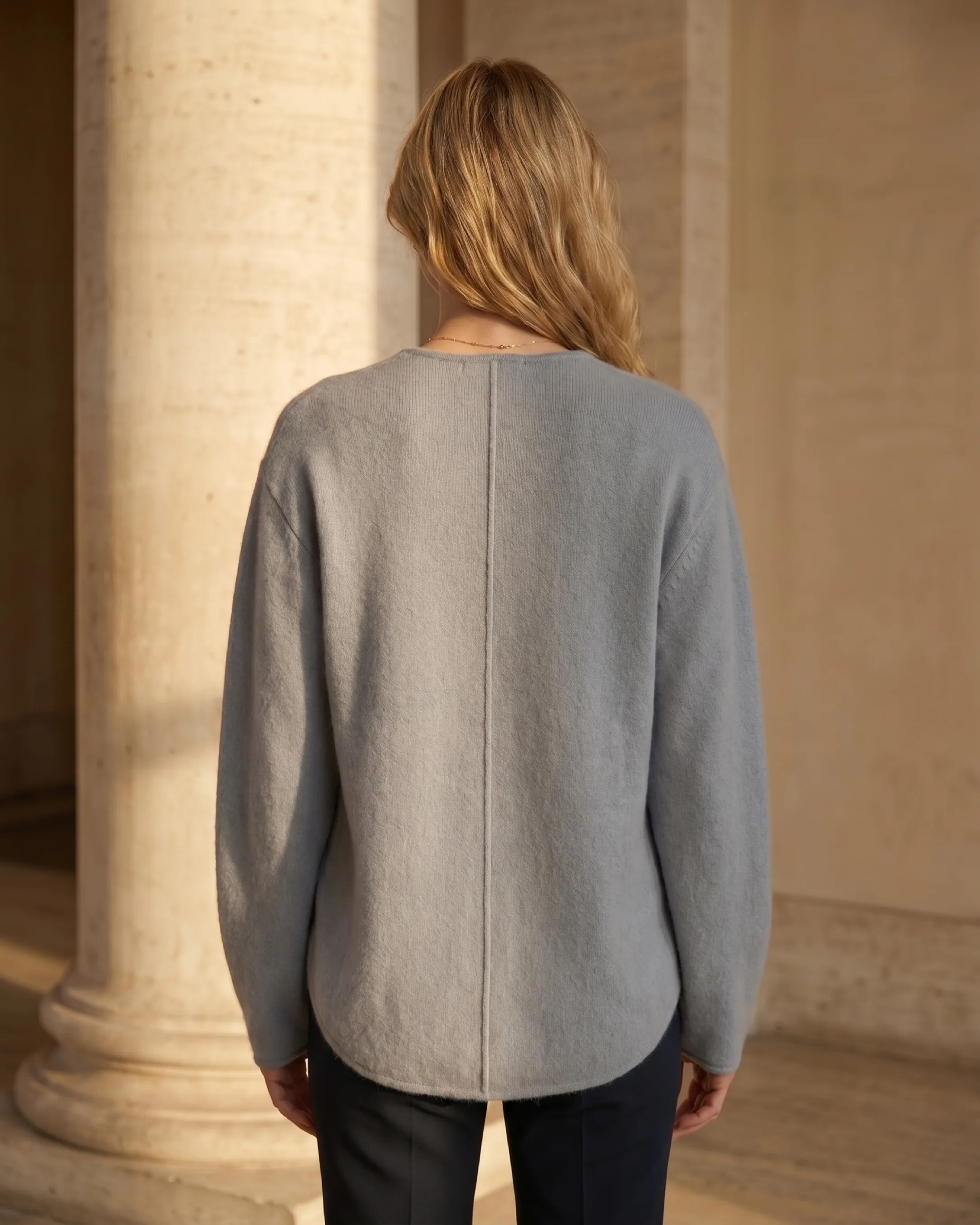 Hugo Caesar Tassi Lucretia full-length rear view showing the smooth knit back panel and curved hem