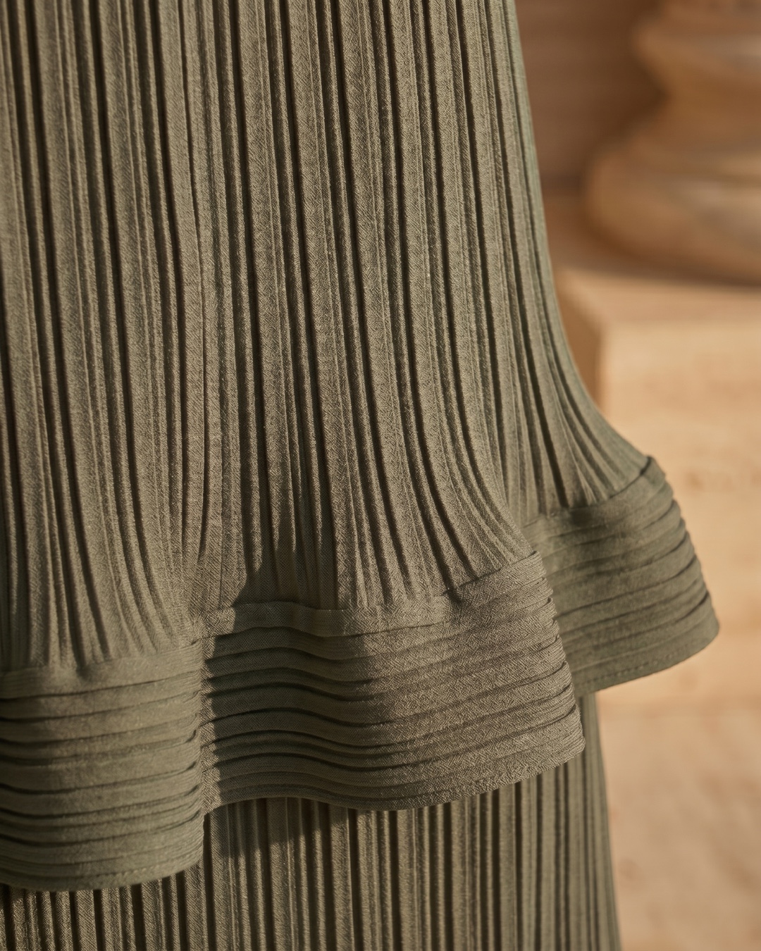 Hugo Caesar Tassi Munatia macro of the fine micro-pleated spandex-blend crepe with a horizontal pleated ruffle flounce in Verde Antico sage green