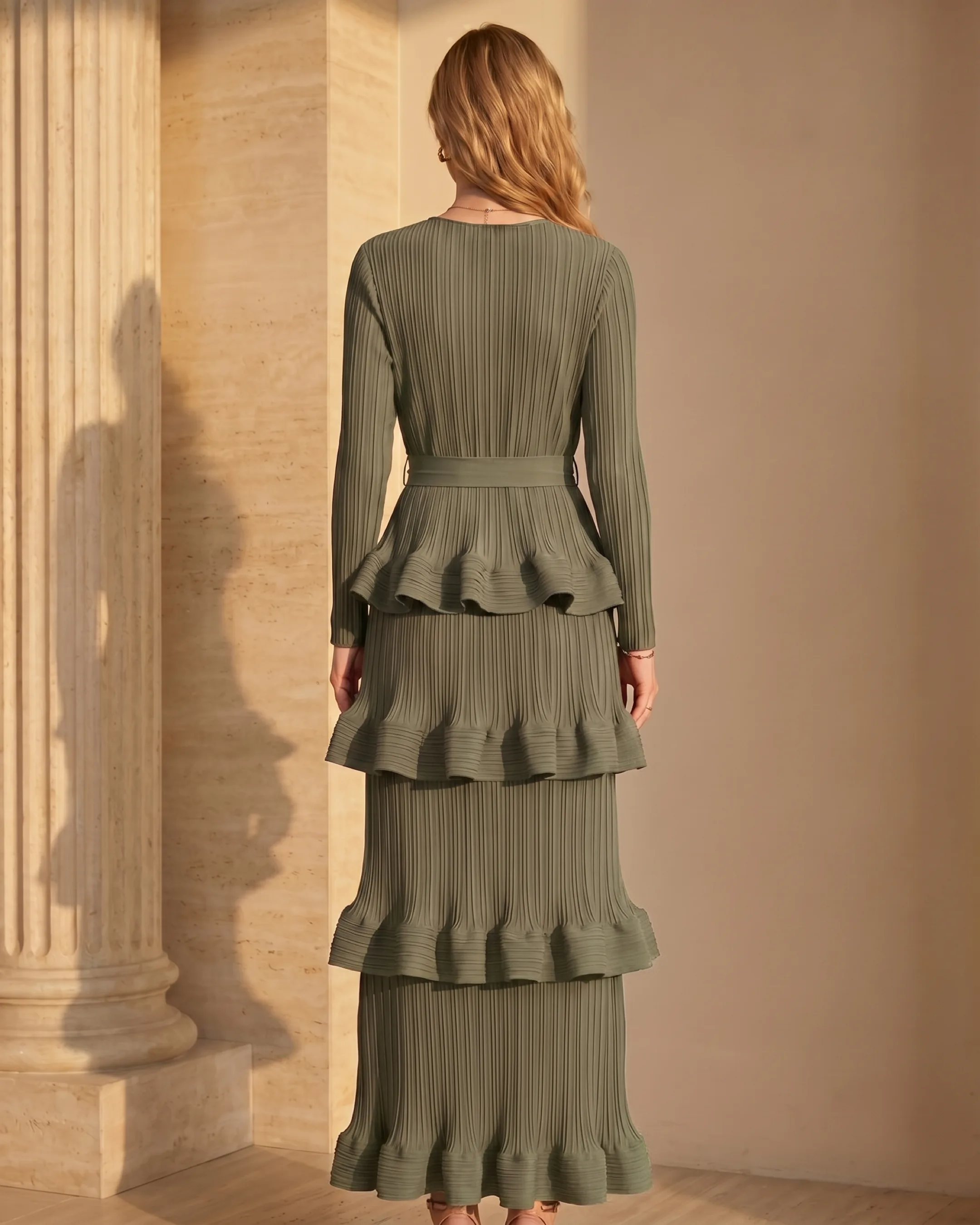 Hugo Caesar Tassi Munatia full-length rear view showing the pleated bodice, bow belt tied at the back and tiered pleated ruffle column falling to the maxi hem
