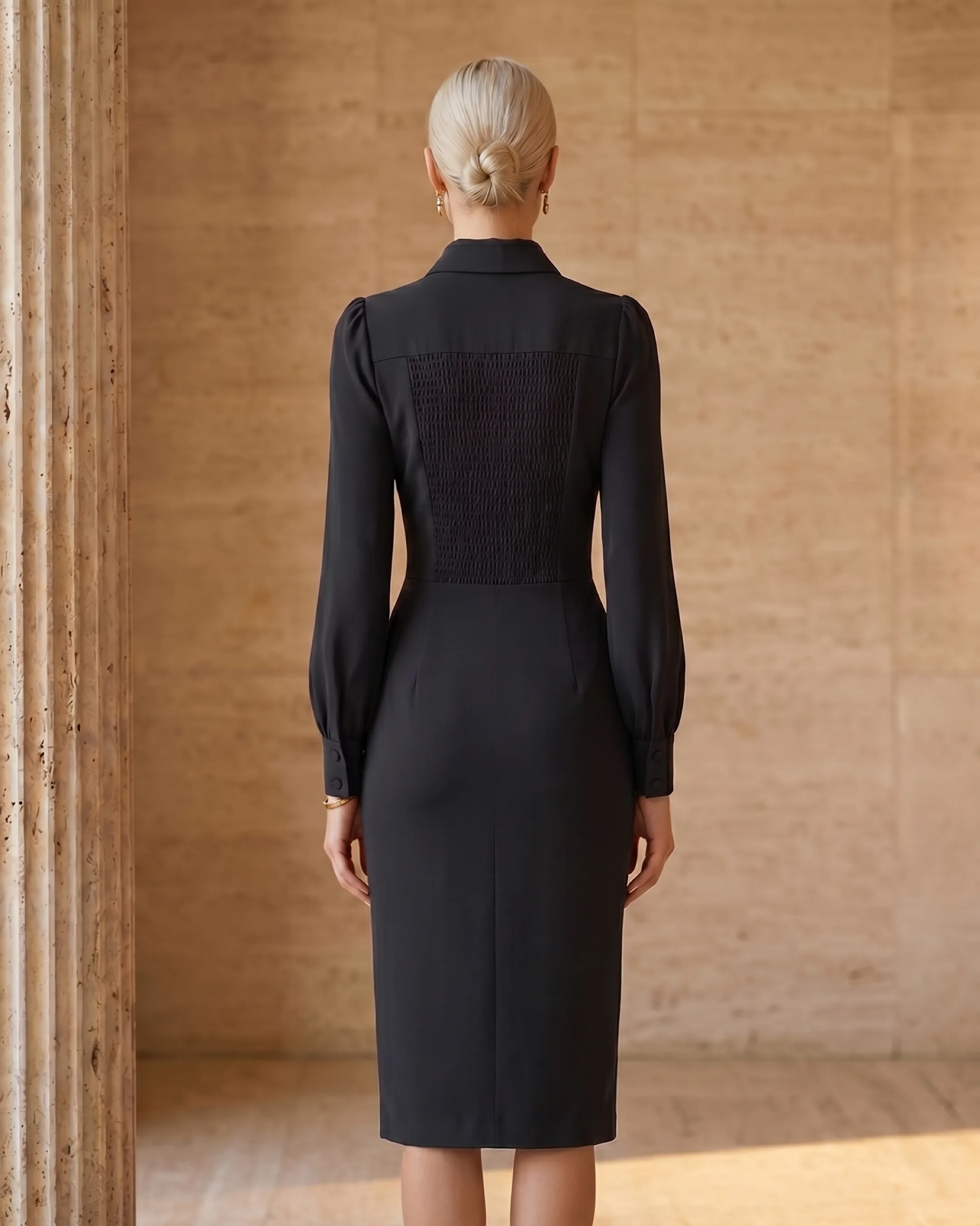 Hugo Caesar Tassi Octavia full-length rear view showing the smocked back panel, collar and fitted midi line in Basalt