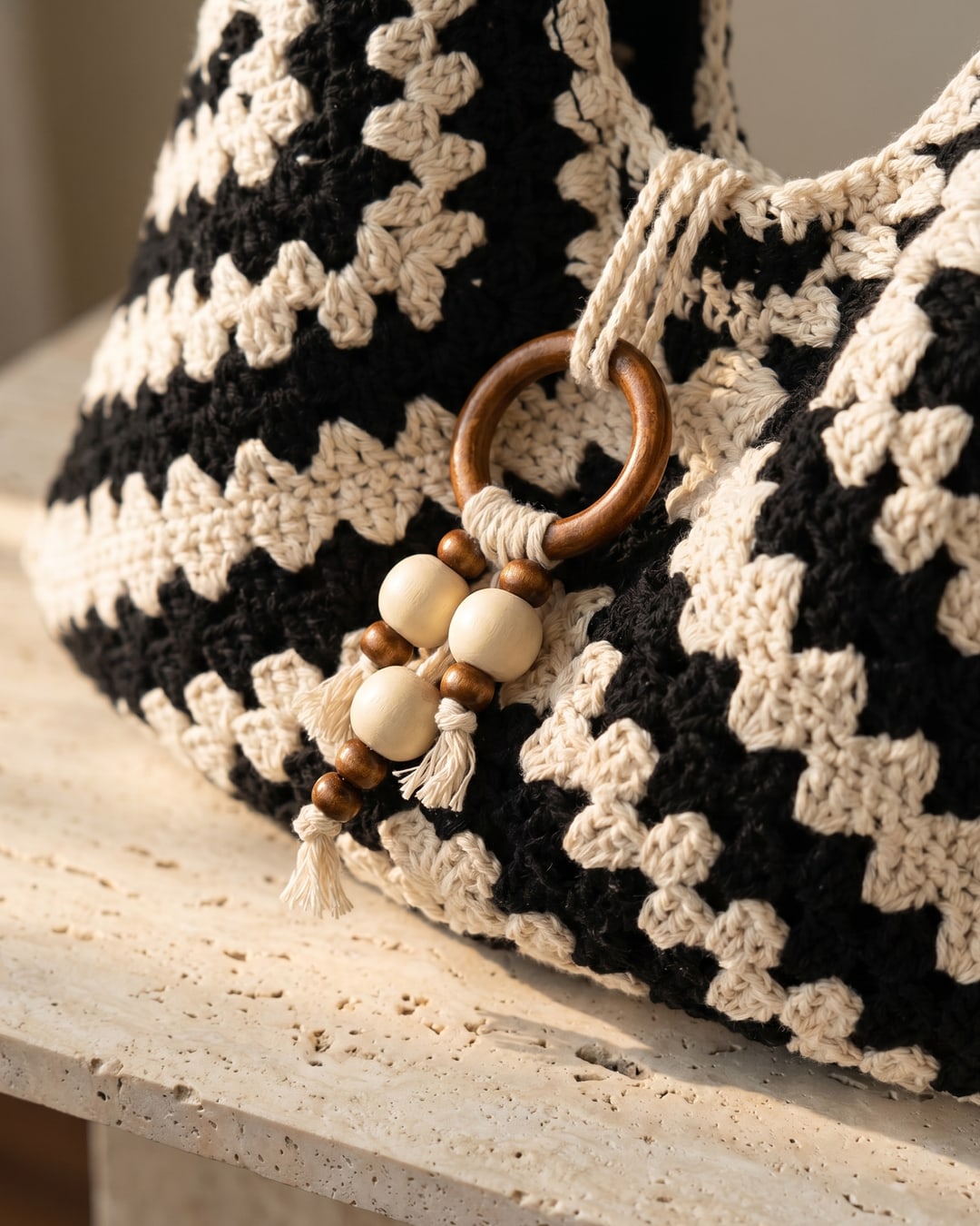 Macro detail of the Ostia hand-crocheted chevron weave and wooden-ring drawstring