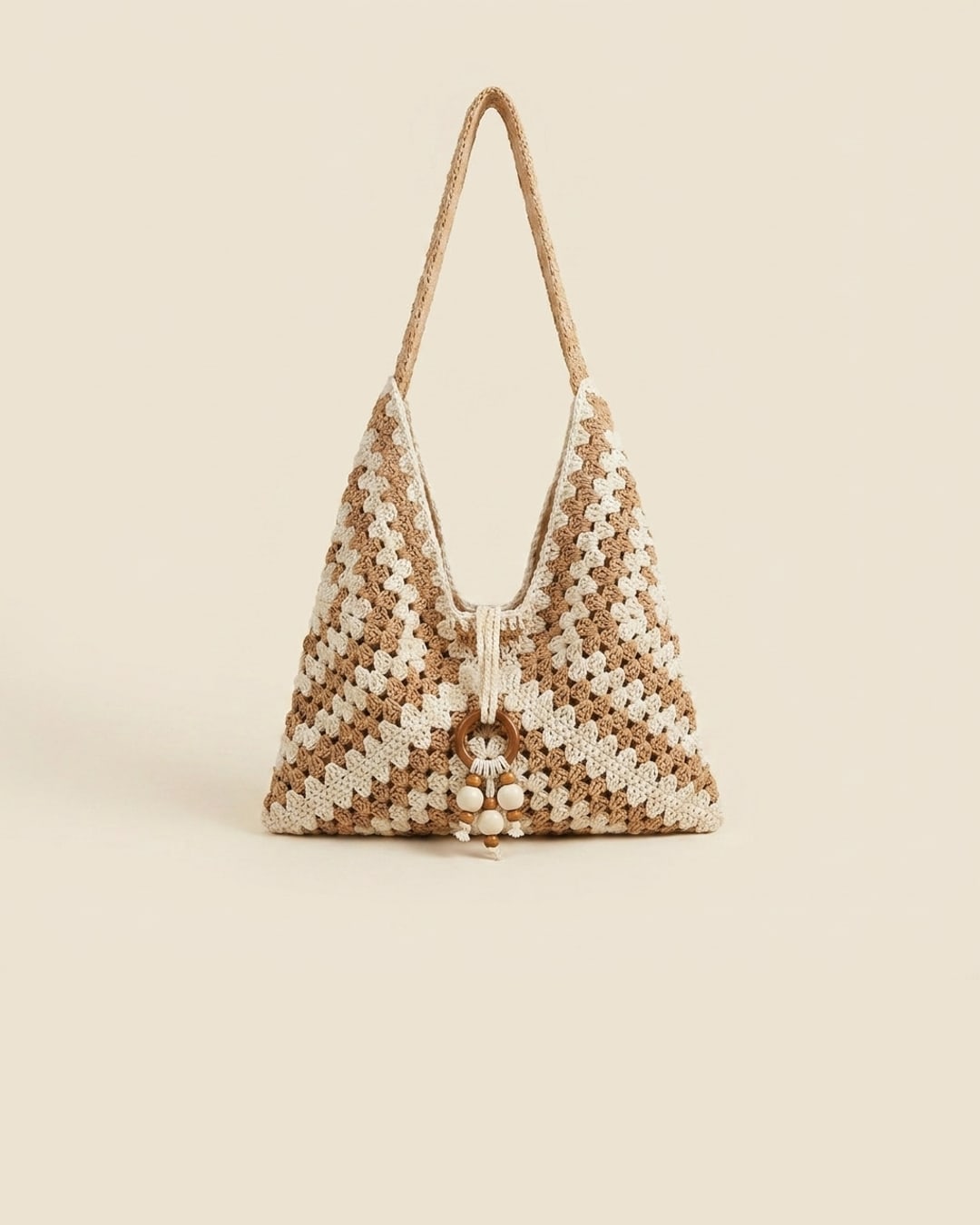 The Ostia tote in Travertine — a clean studio packshot of the khaki and cream hand-crocheted chevron weave