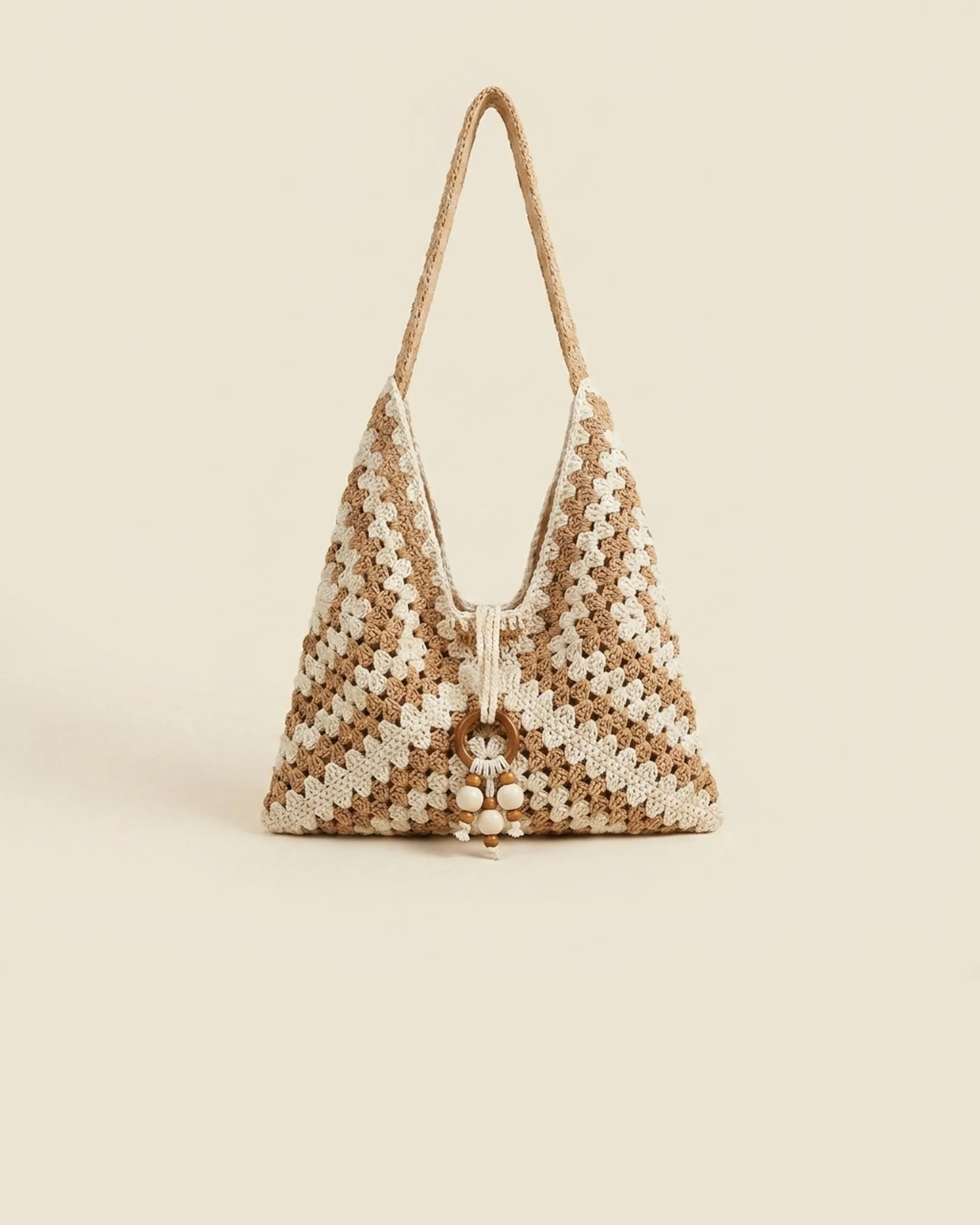 The Ostia tote in Travertine — a clean studio packshot of the khaki and cream hand-crocheted chevron weave