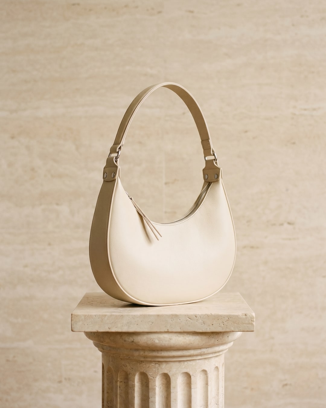 Hugo Caesar Tassi minimalist crescent leather shoulder bag in Avorio — studio packshot, Hugo Caesar Tassi