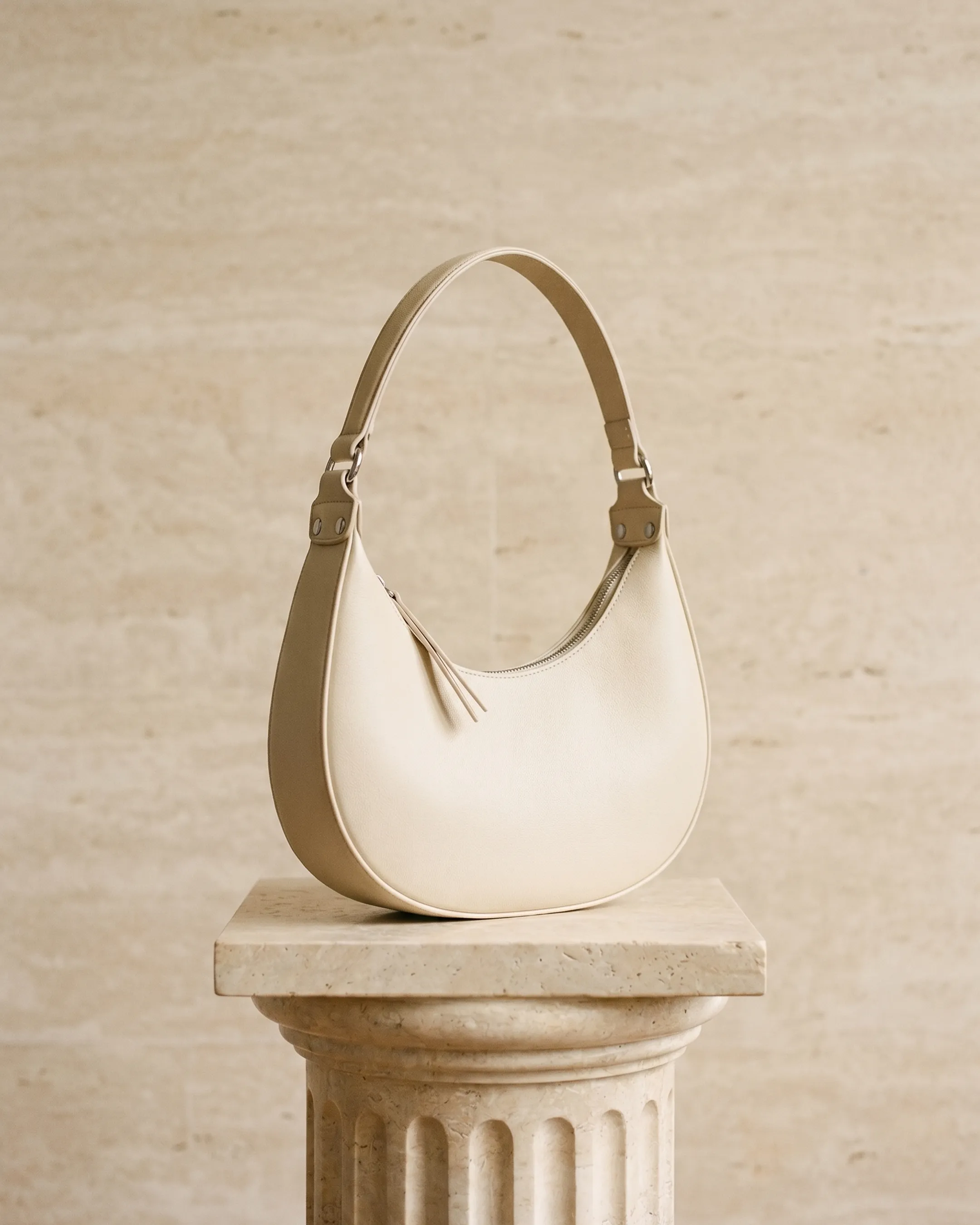 Hugo Caesar Tassi minimalist crescent leather shoulder bag in Avorio — studio packshot, Hugo Caesar Tassi