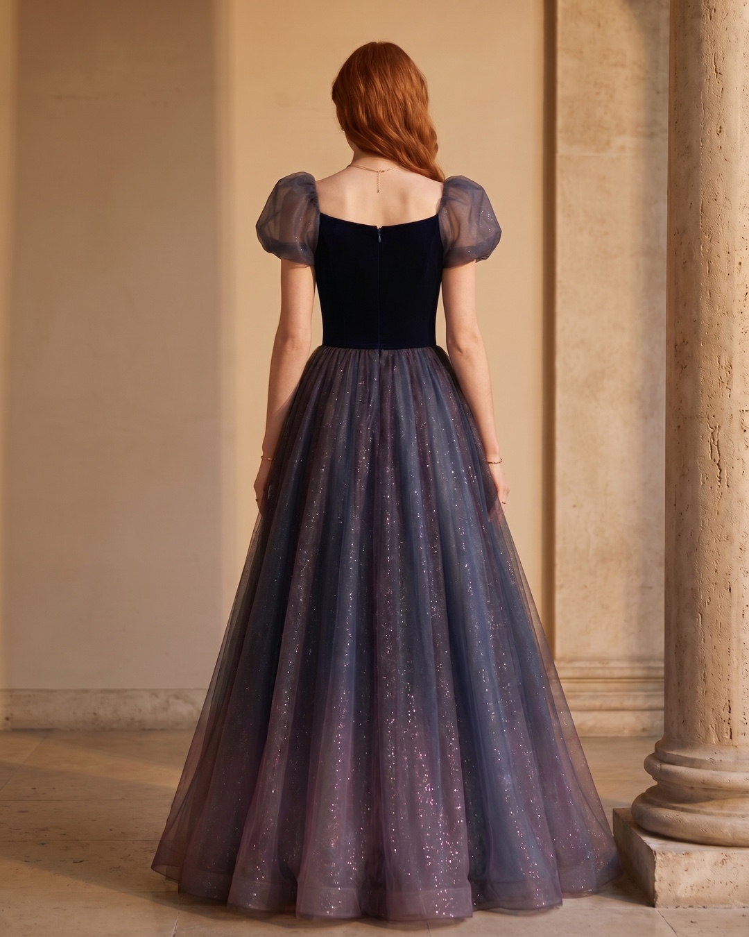 Hugo Caesar Tassi Petronia full-length rear view showing the square back neckline, centre-back closure, bubble sleeves and full galaxy-tulle ballgown skirt in Cobalto