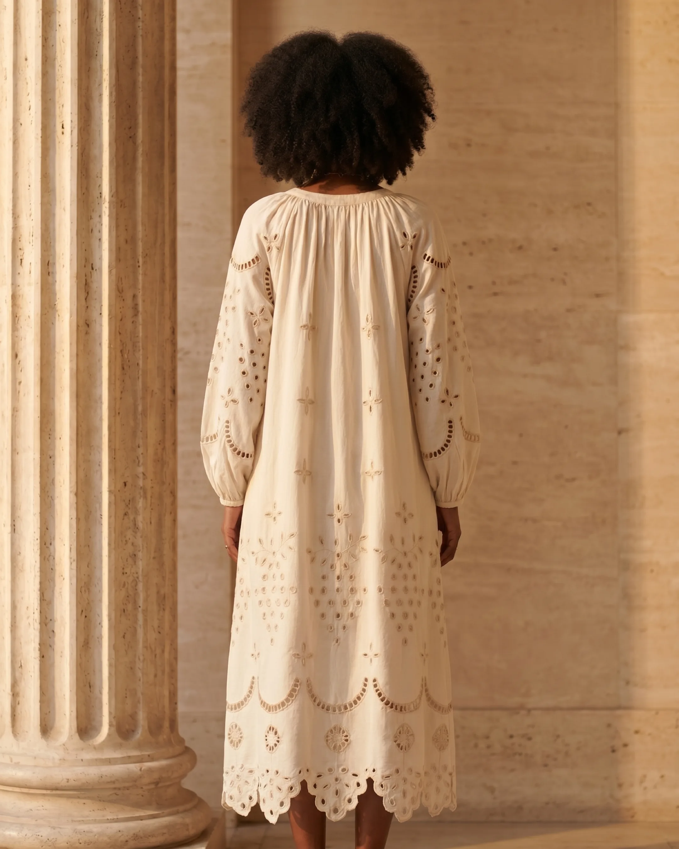 Full-length rear view of the Hugo Caesar Tassi Plautina embroidered cotton maxi showing the gathered yoke and scalloped hem