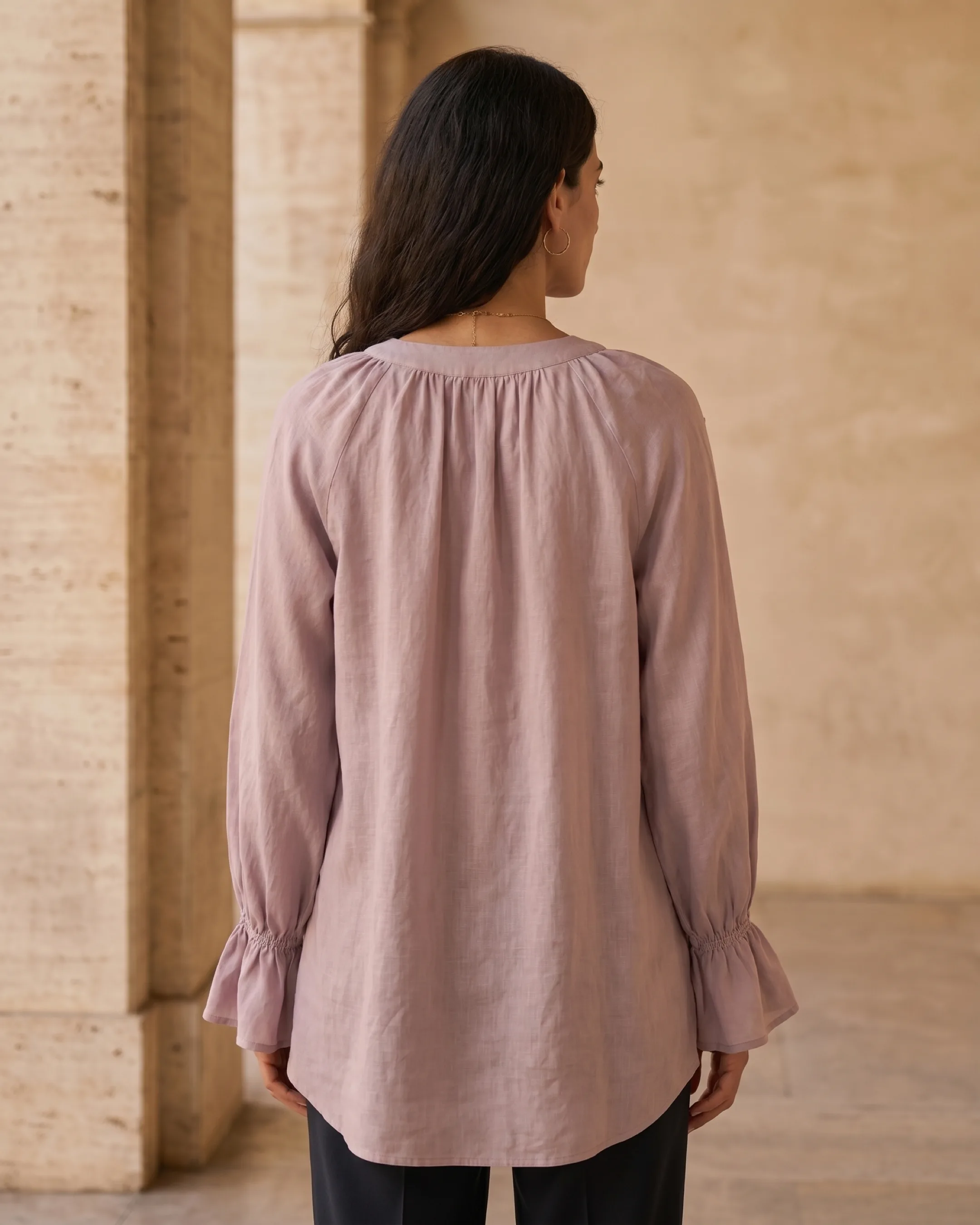Hugo Caesar Tassi Roscia full-length rear view showing the gathered round back neck, ruffled bell cuffs and dipped high-low back hem in Lavanda