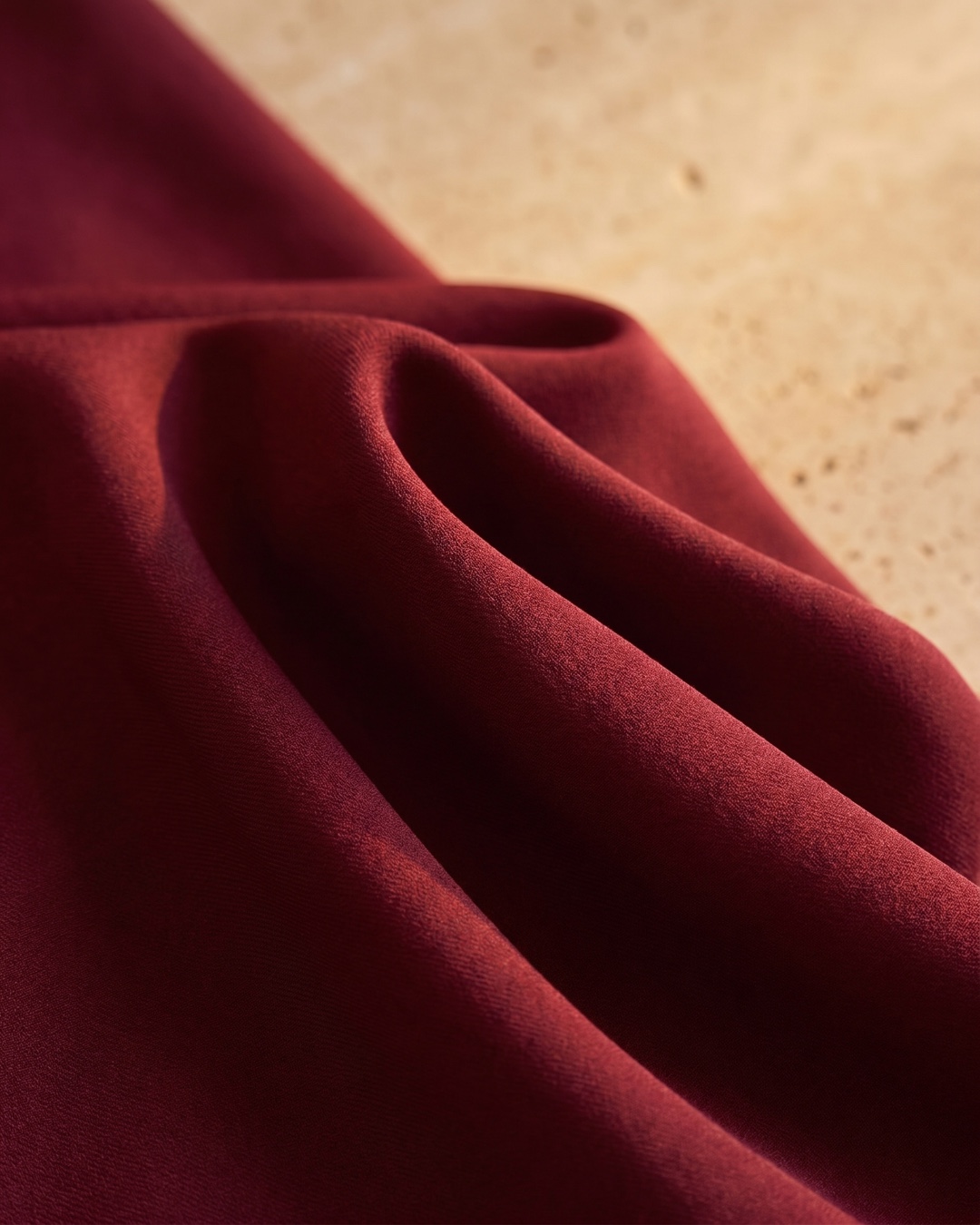 Hugo Caesar Tassi Sabina macro of the fluid matte satin in deep Porpora wine, soft folds catching golden light