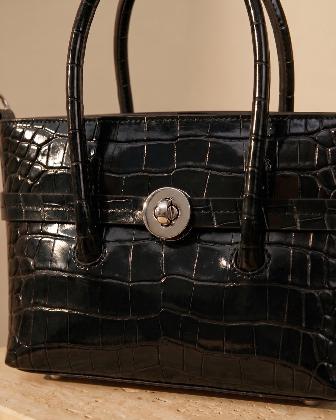 Hugo Caesar Tassi Salaria macro of the glossy croc-embossed leather grain, front strap and polished silver turn-lock closure