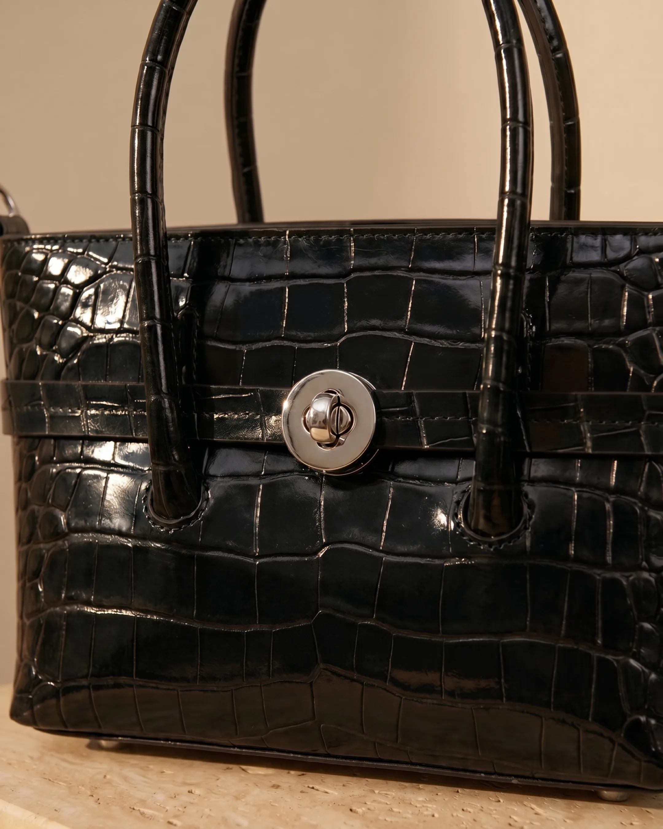 Hugo Caesar Tassi Salaria macro of the glossy croc-embossed leather grain, front strap and polished silver turn-lock closure