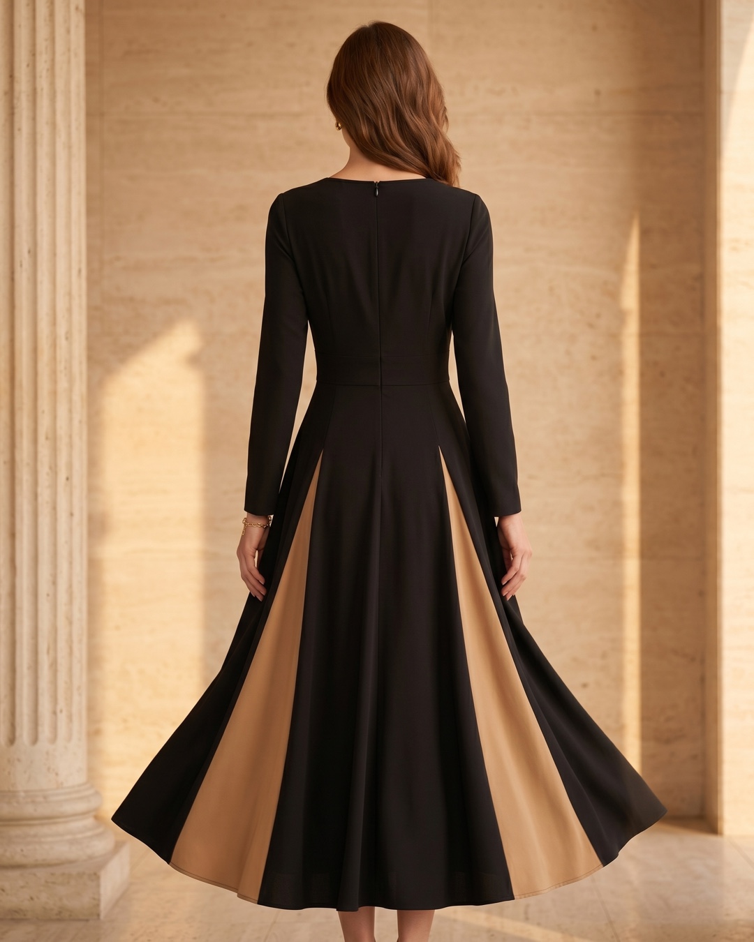 Hugo Caesar Tassi Sentia full-length rear view showing the fitted back bodice, concealed back zip and the large-swing skirt with the contrast godet flaring from behind