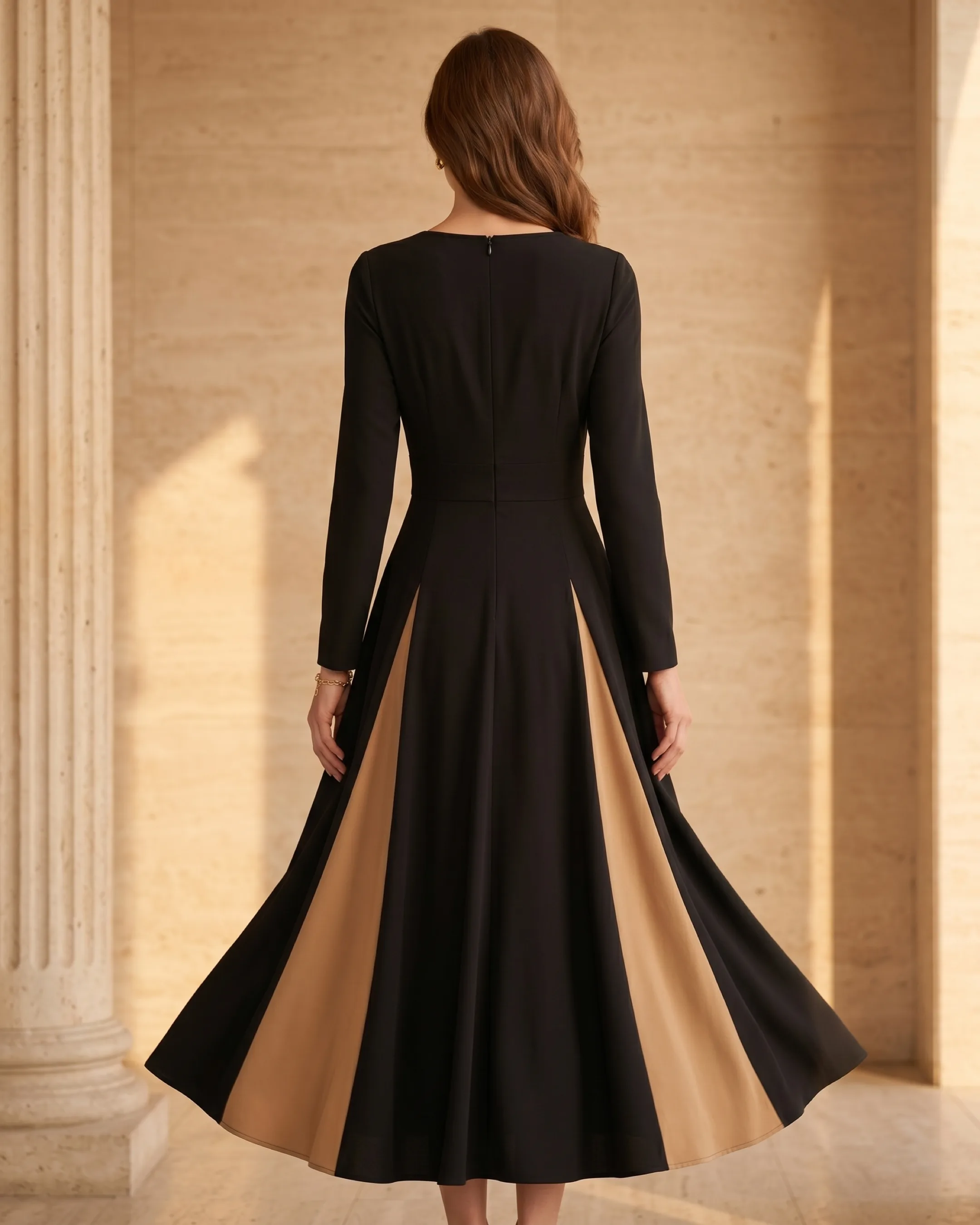Hugo Caesar Tassi Sentia full-length rear view showing the fitted back bodice, concealed back zip and the large-swing skirt with the contrast godet flaring from behind