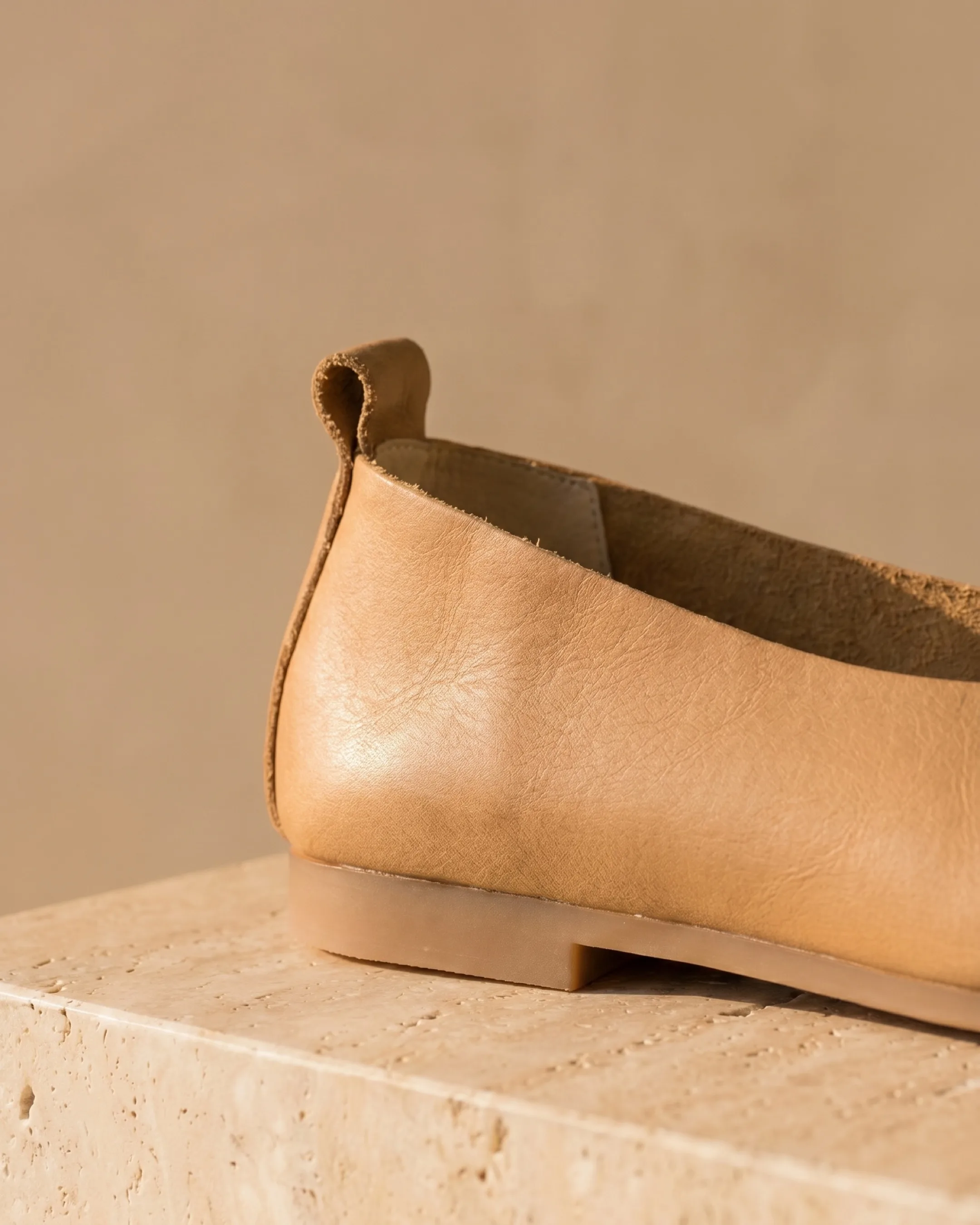 Hugo Caesar Tassi Septima macro of the soft oil-finish cowhide grain, the back pull-tab and the low natural-tan leather heel