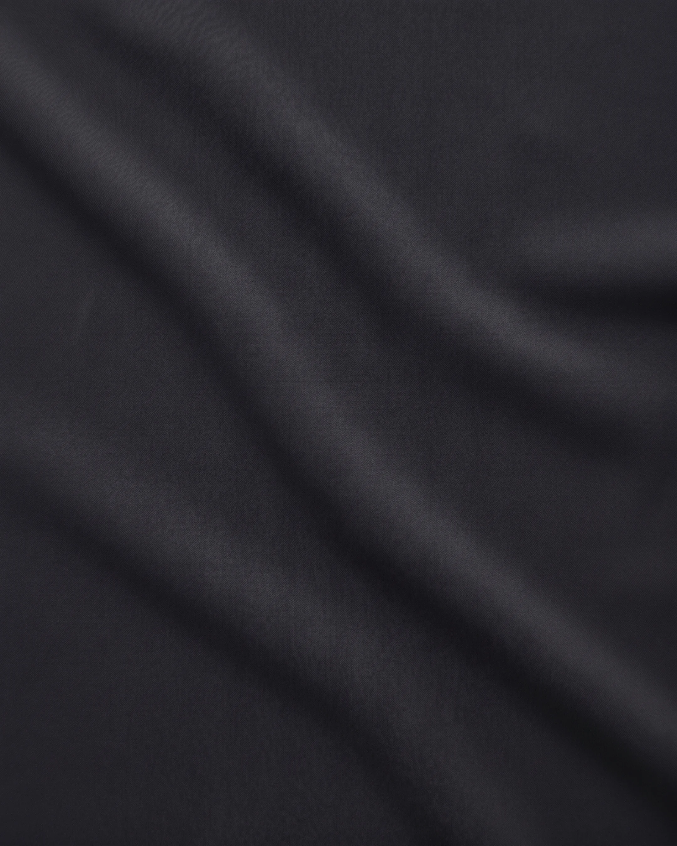 Close detail of the matte crepe and fine vertical knife-pleating of the Hugo Caesar Tassi Tullia evening gown
