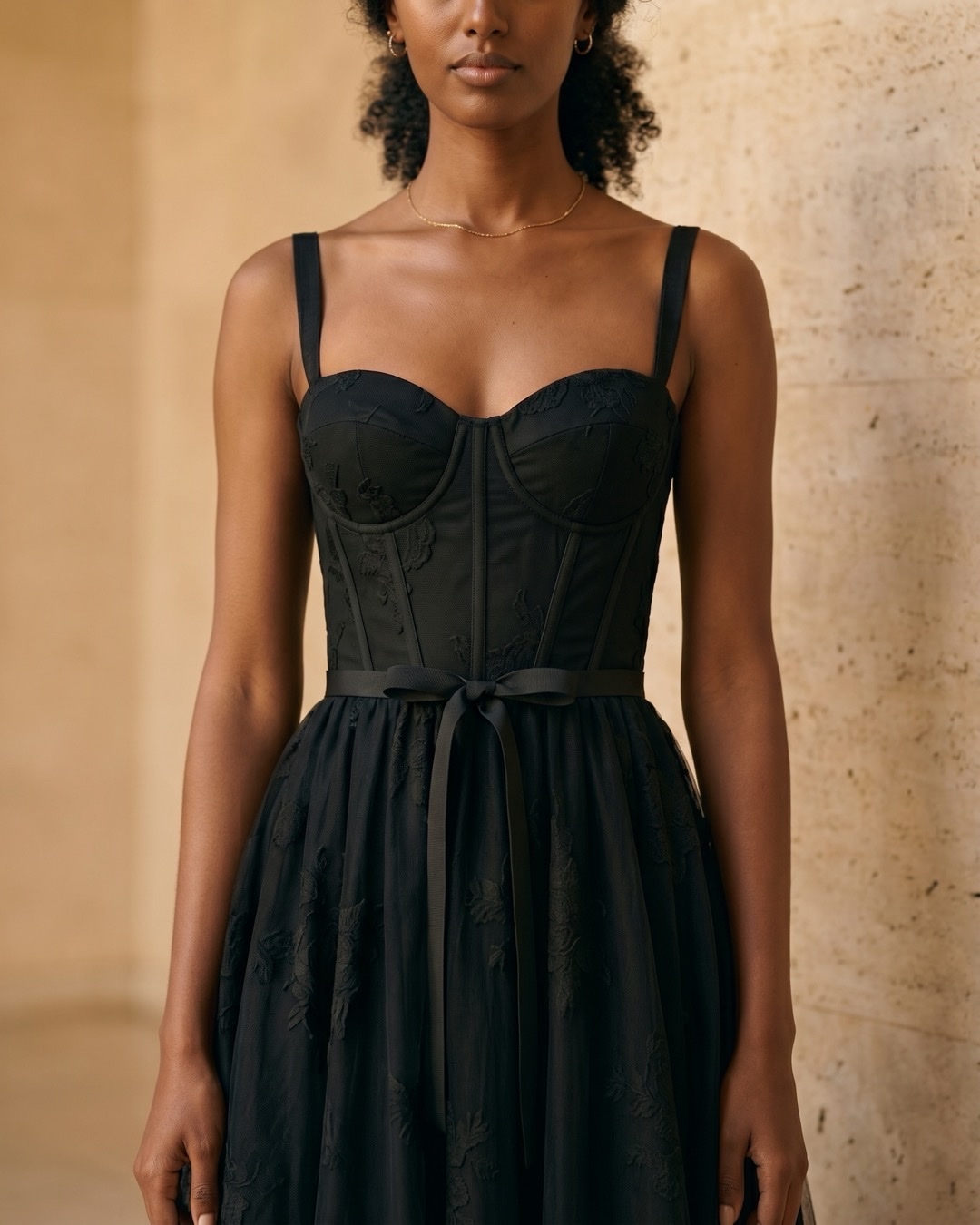 Hugo Caesar Tassi Volusia close-up of the sweetheart neckline, boned corset bodice and self-tie ribbon over tonal black tulle