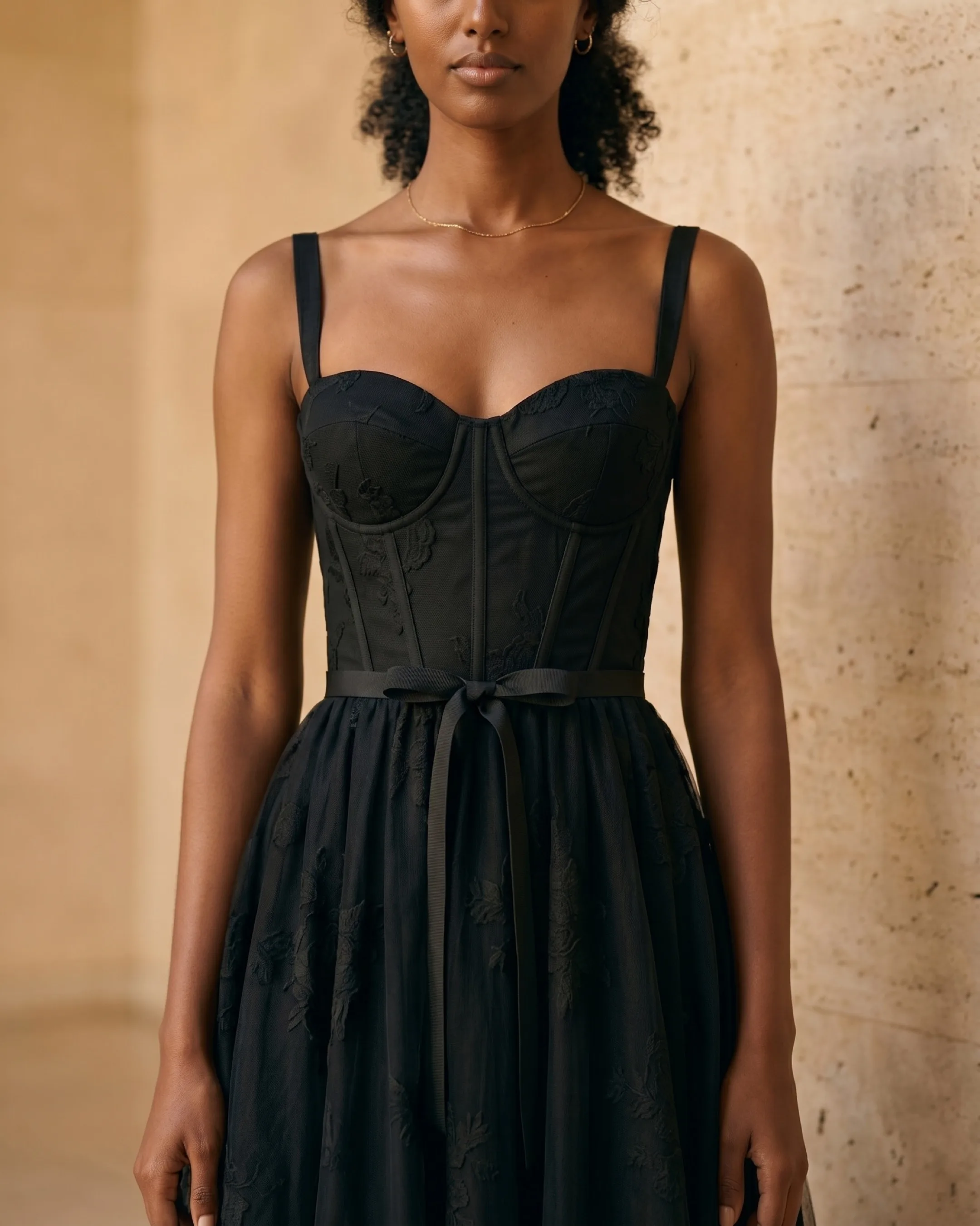 Hugo Caesar Tassi Volusia close-up of the sweetheart neckline, boned corset bodice and self-tie ribbon over tonal black tulle