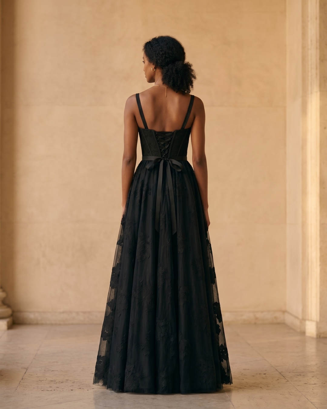 Hugo Caesar Tassi Volusia full-length rear view showing the laced corset back, ribbon bow and full black tulle skirt