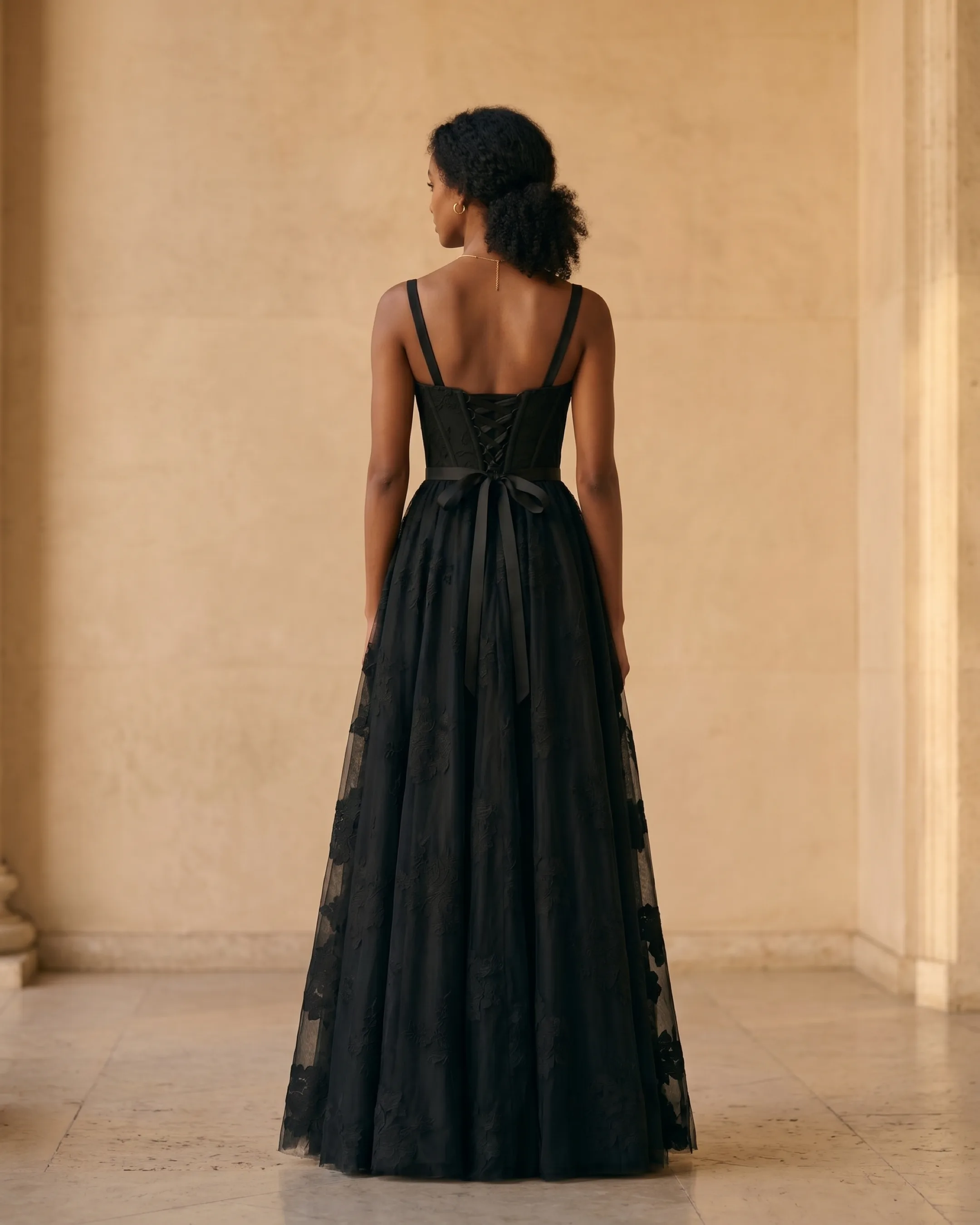 Hugo Caesar Tassi Volusia full-length rear view showing the laced corset back, ribbon bow and full black tulle skirt